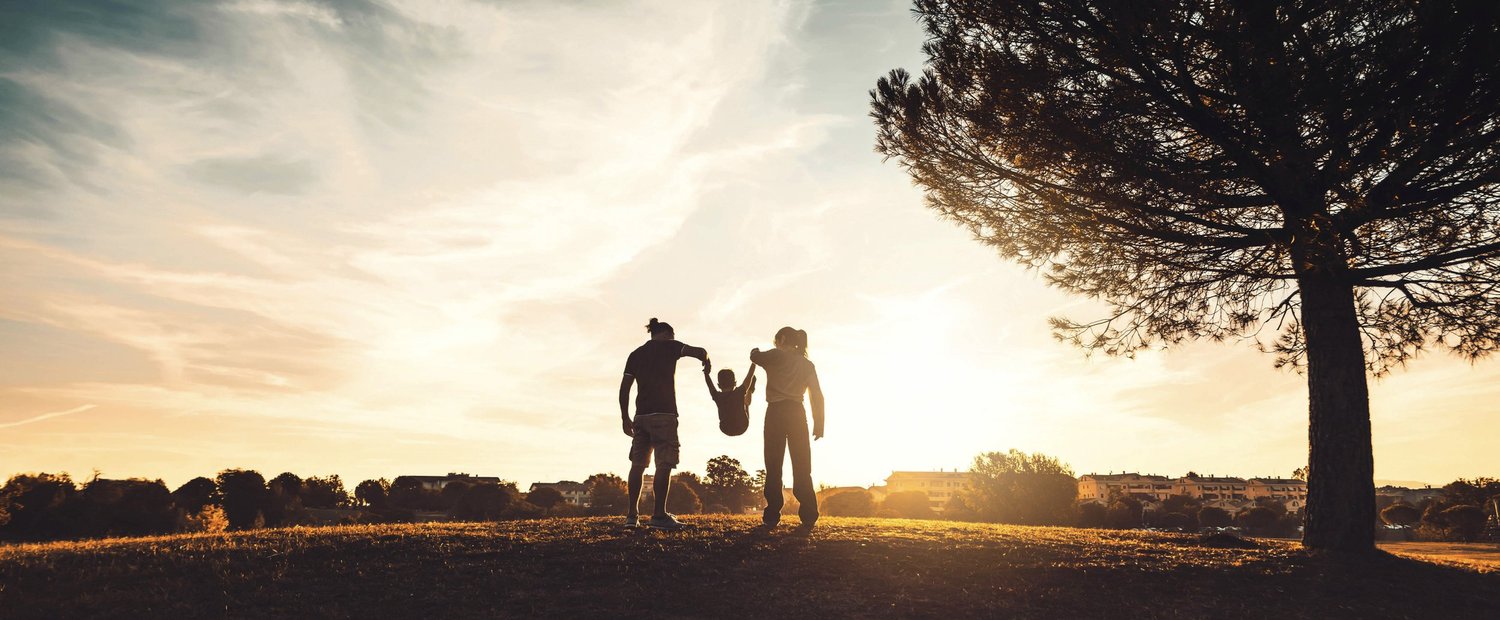 A family spending time together outdoors at sunset